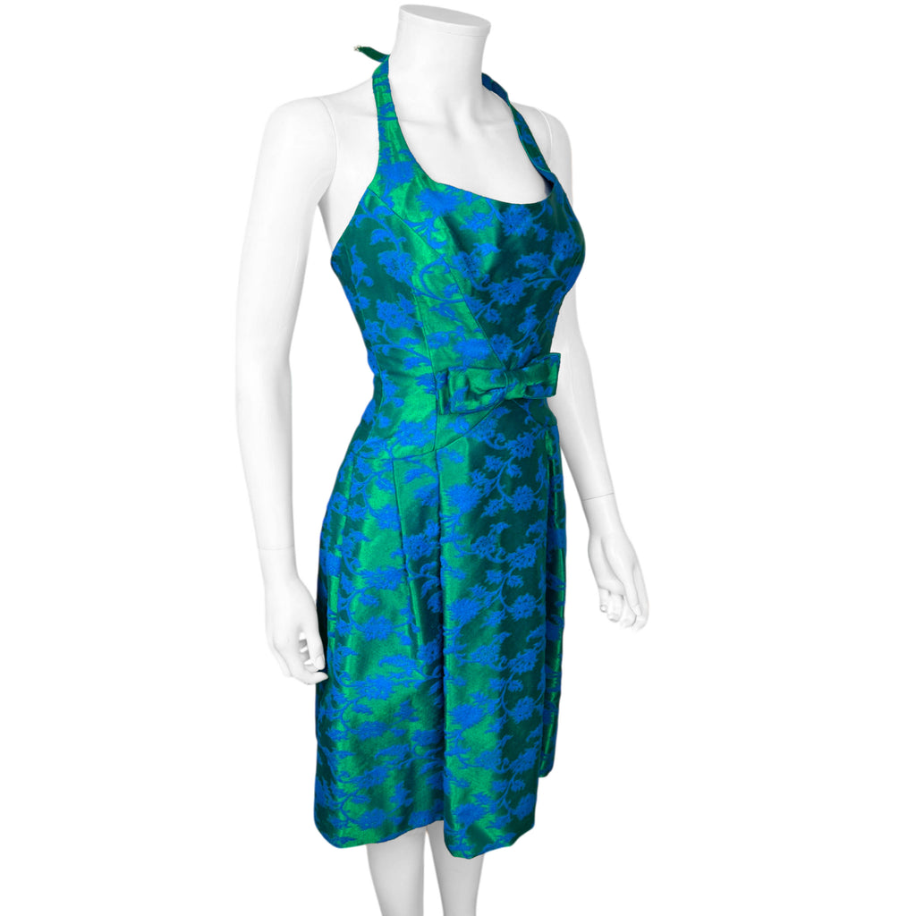 Three-quarter view of vintage Rappi emerald-green and cobalt-blue floral brocade cocktail dress with waist bow