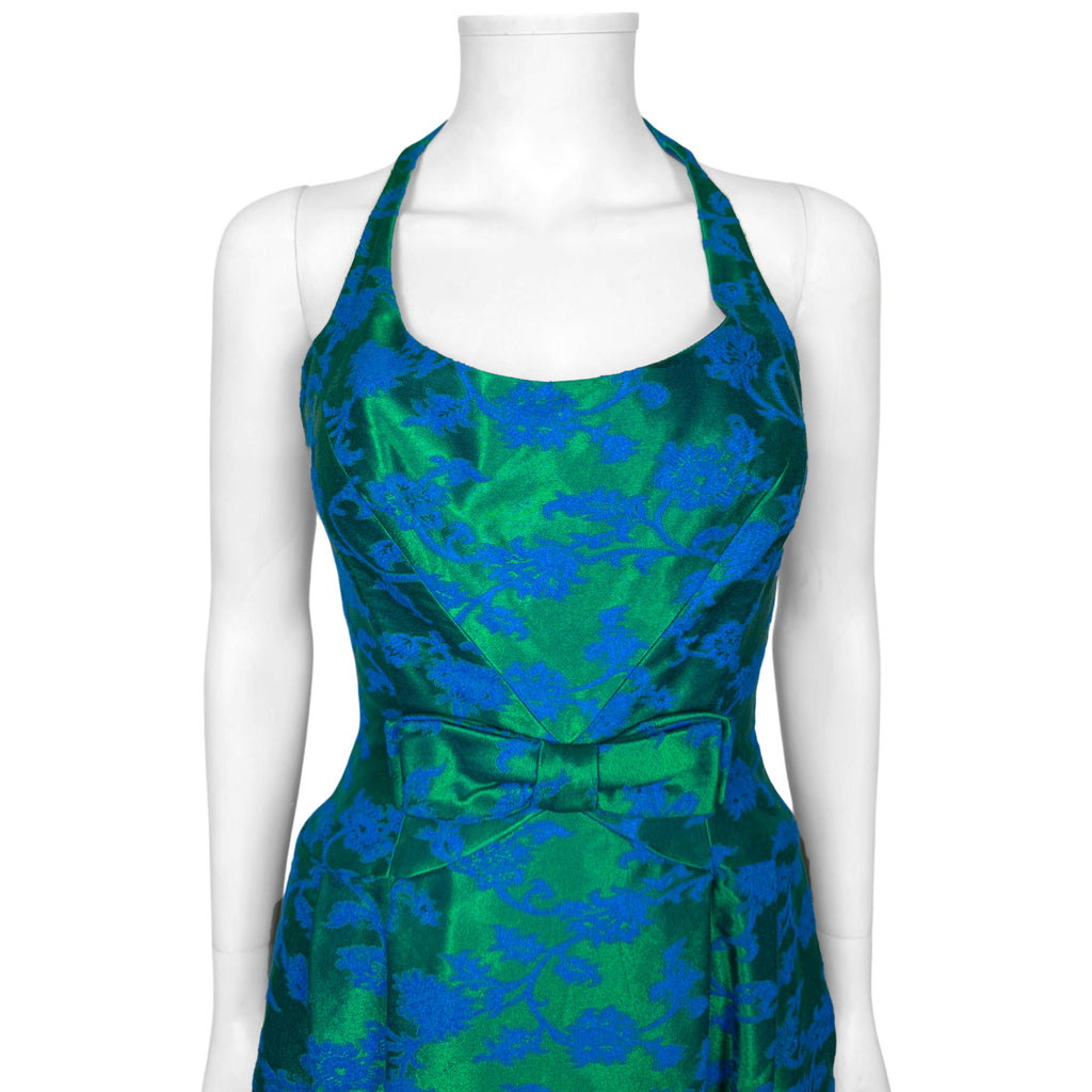 Close-up of vintage Rappi cocktail dress showing halter neckline, diagonal bodice seams and decorative waist bow