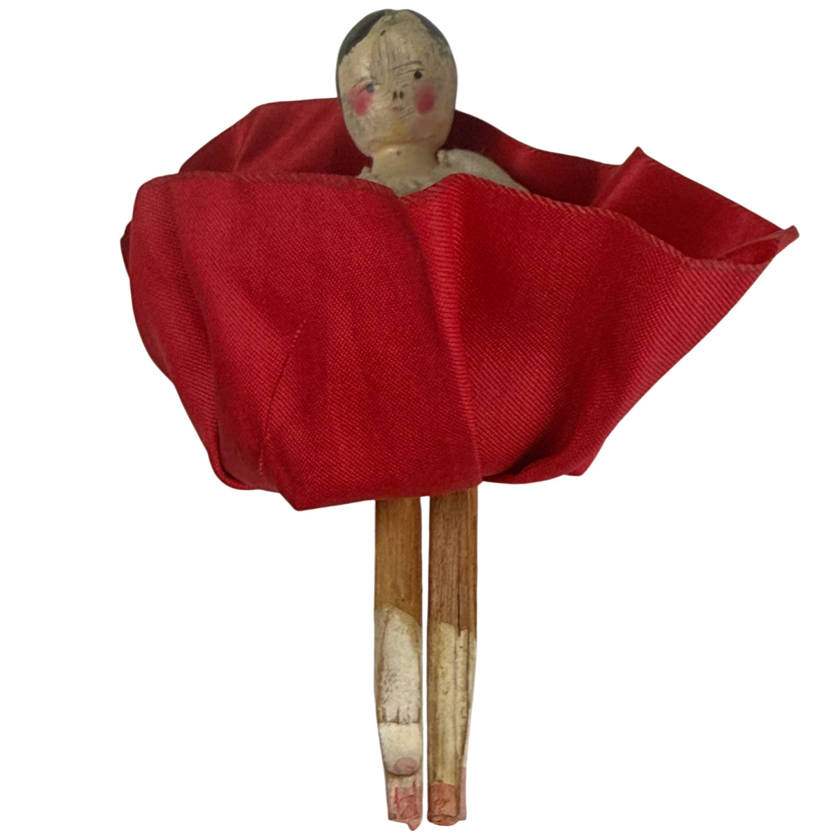 Antique wooden Dutch doll with red silk skirt lifted to reveal articulated wooden legs and remnants of original painted finish