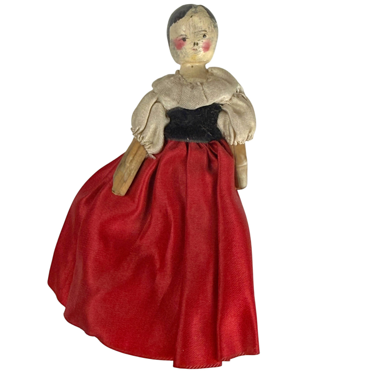 Antique German Grödnertal wooden peg doll, front view, wearing original red silk skirt, black velvet bodice and cream silk blouse