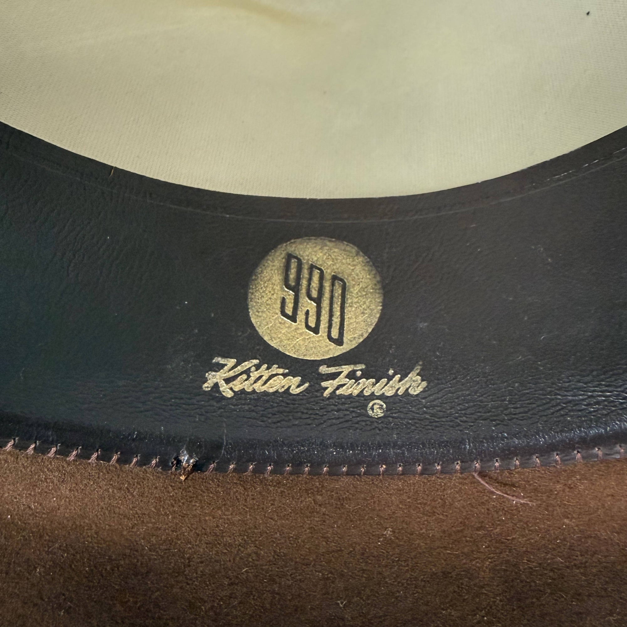 Close-up of 990 Kitten Finish stamp inside sweatband