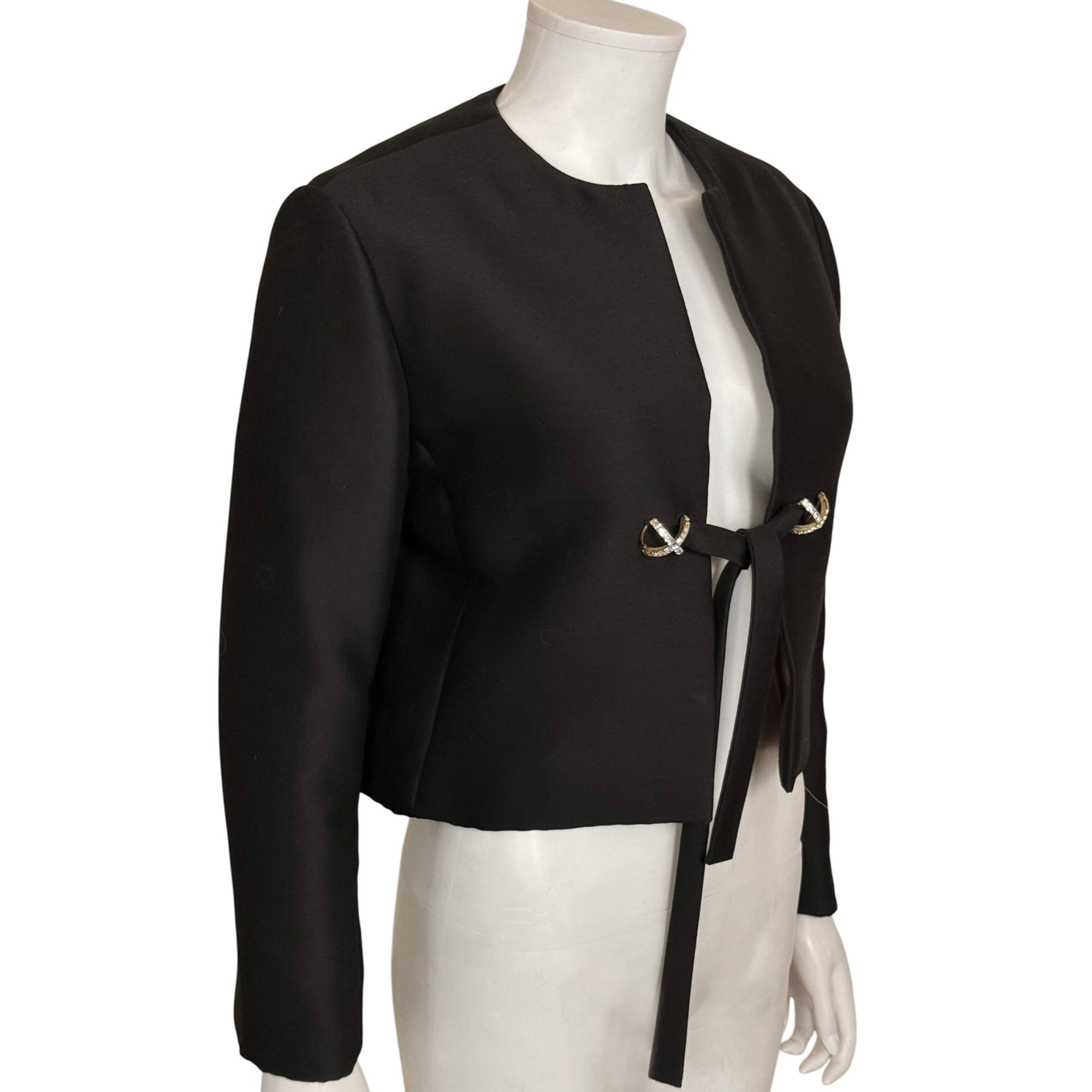Angled view of vintage 1960s black silk cropped evening jacket 