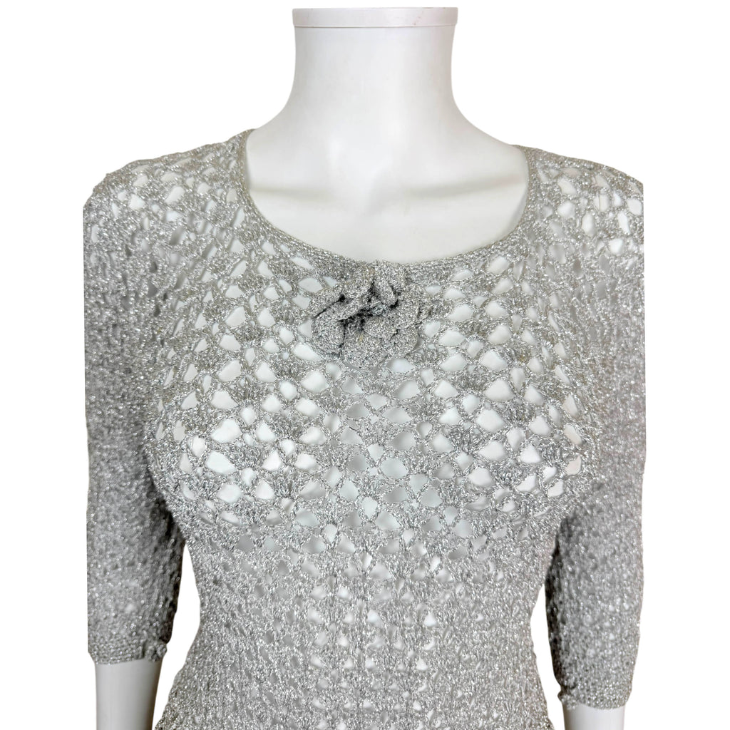 close up view of bodice of vintage 1960s silver metallic crochet dress