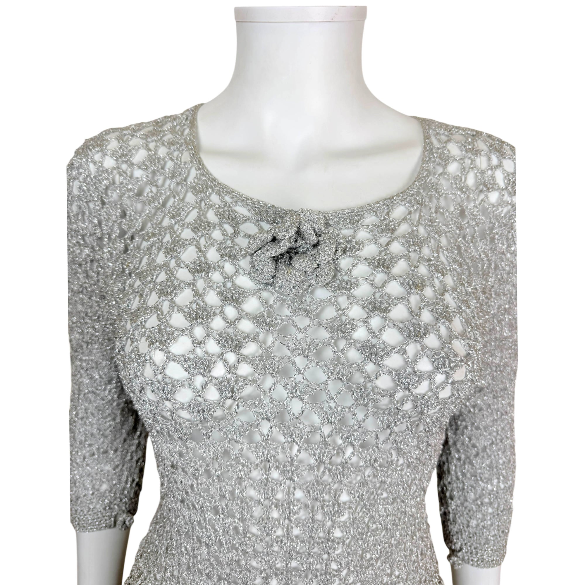 close up view of bodice of vintage 1960s silver metallic crochet dress
