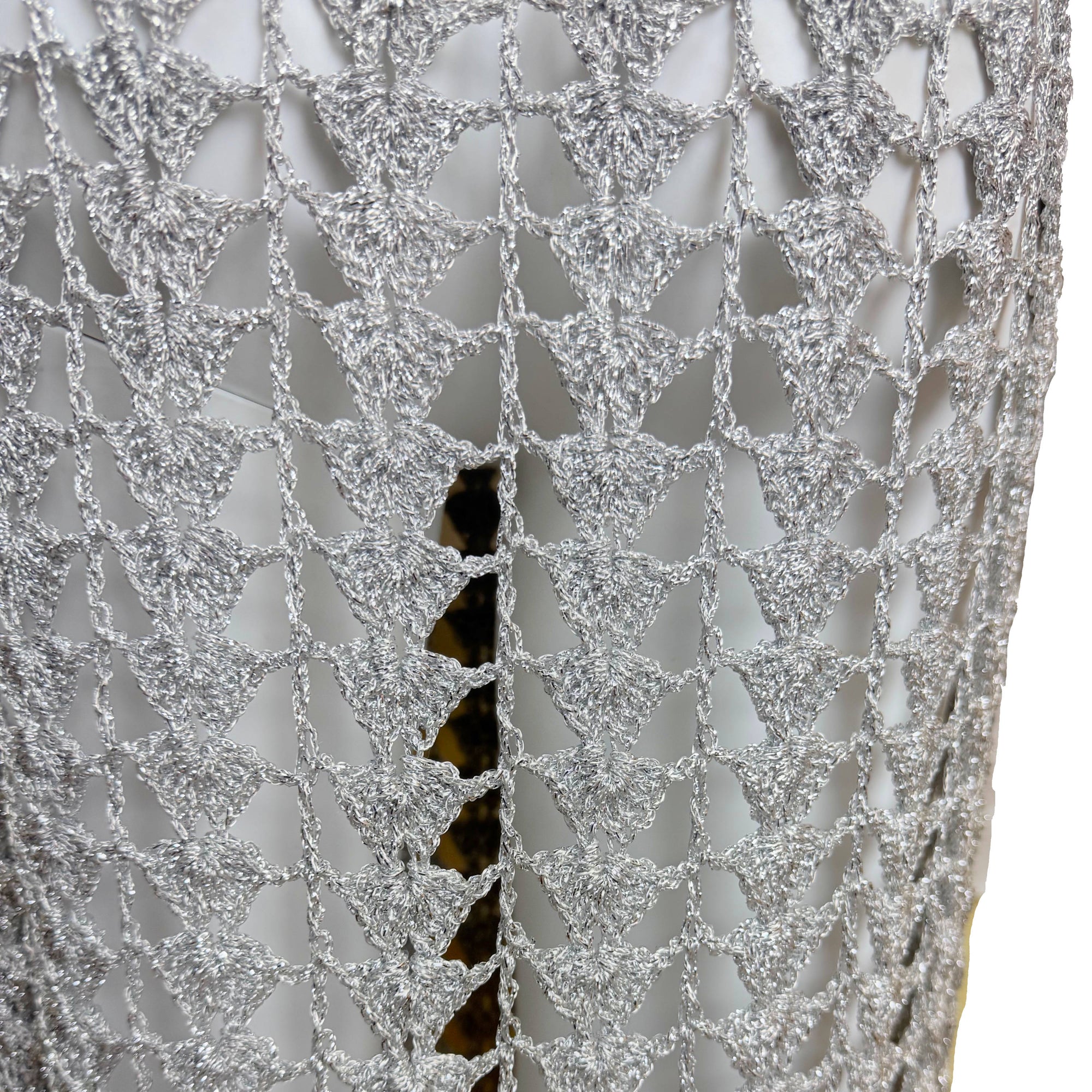 close up detail of vintage 1960s silver metallic crochet dress