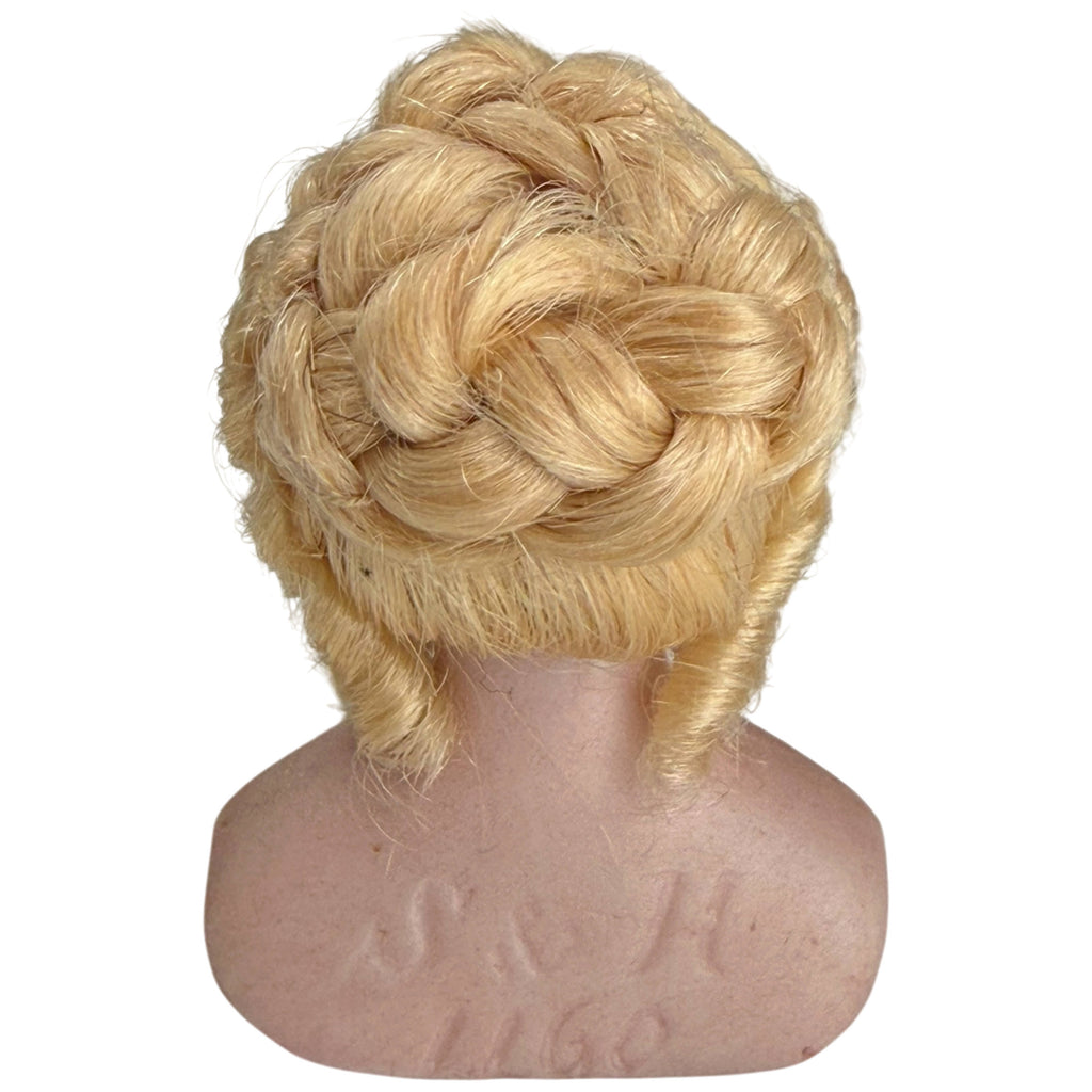 Back view of Simon and Halbig bisque doll bust showing intricate blonde braided wig and impressed S and H 1160 markings