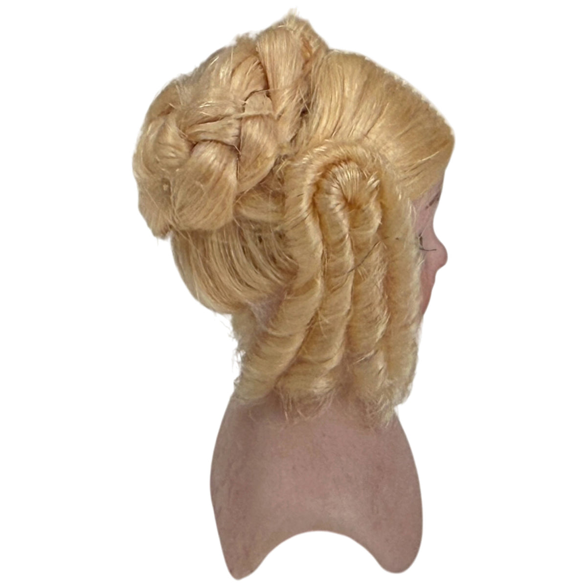Side view of antique Simon and Halbig bisque doll head with glass eyes and elaborate blonde ringlet wig