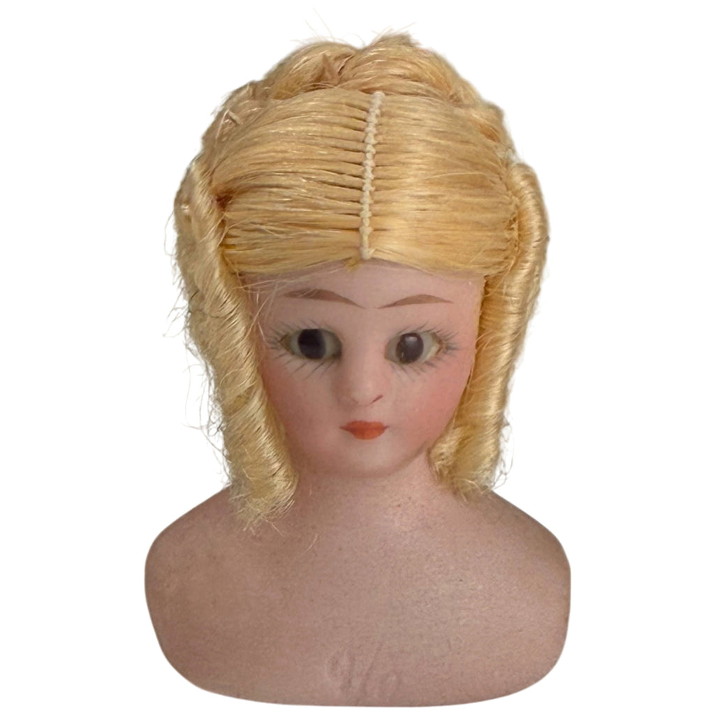 Antique Simon and Halbig Little Women German bisque doll head with glass eyes, blonde wig and painted facial features, front view
