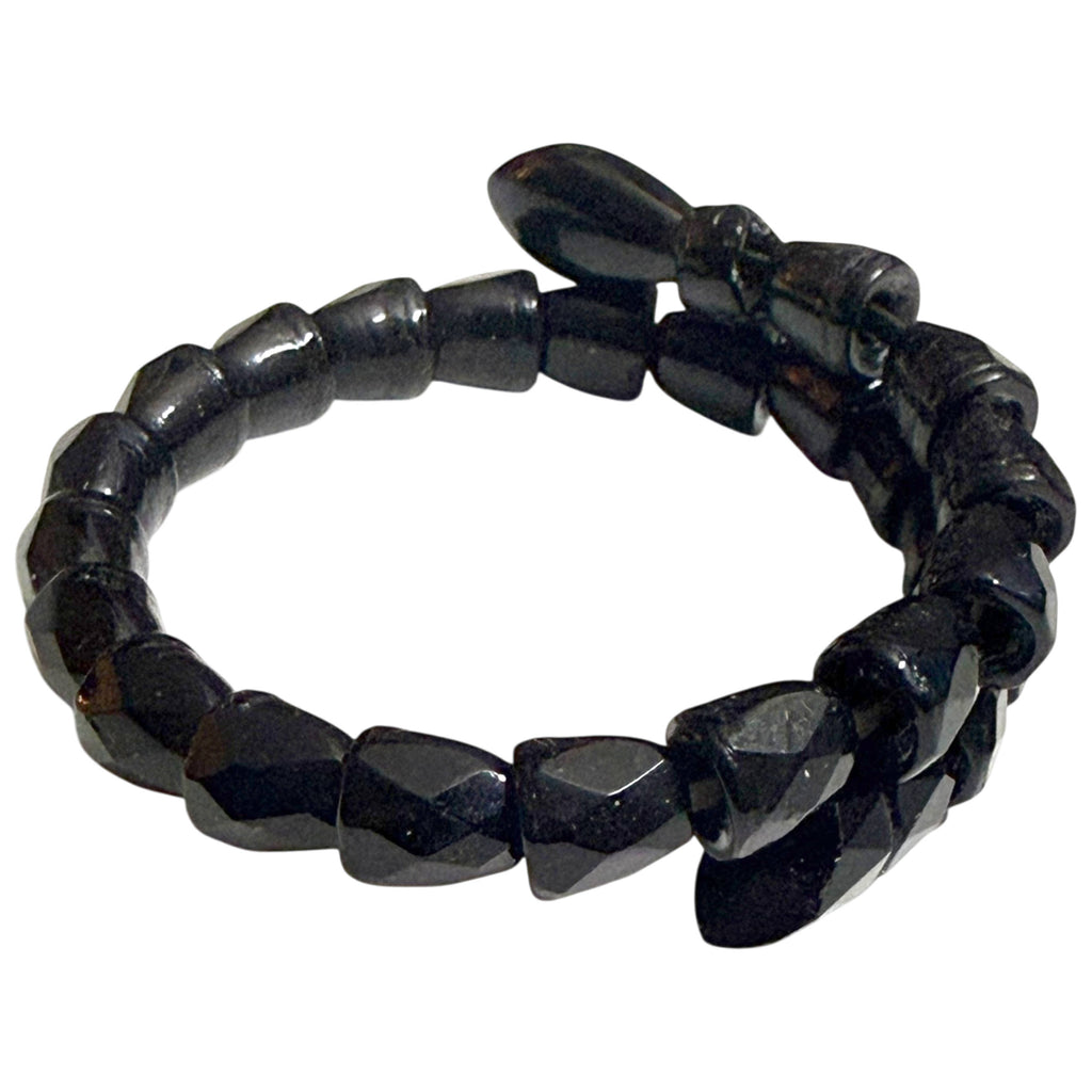 Side view of antique Victorian snake wrap bracelet showing graduated faceted black beads and flexible coil design