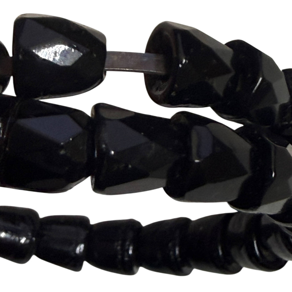 Close-up of irregular individually faceted black beads on Victorian jet serpent bracelet showing exposed internal wire