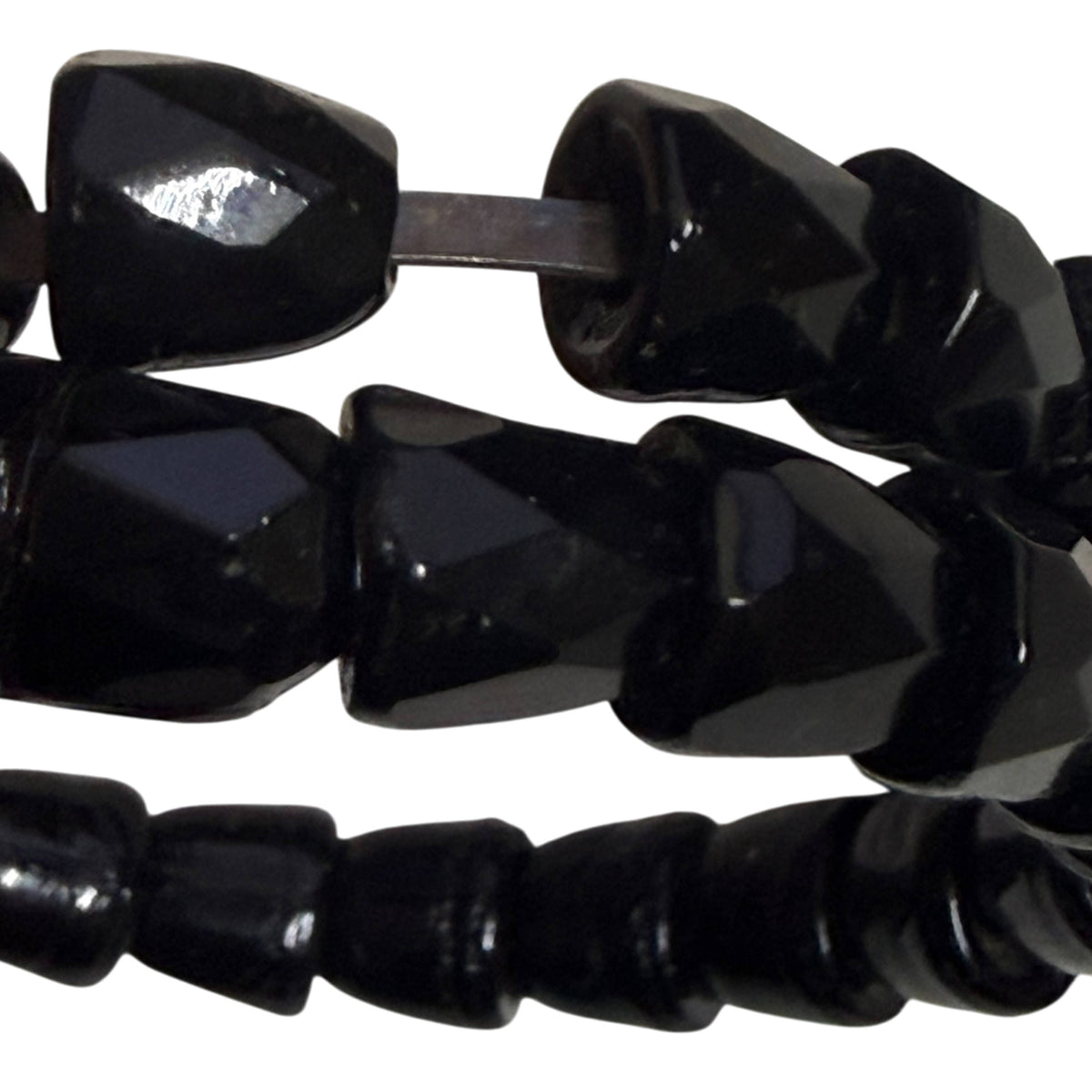 Close-up of irregular individually faceted black beads on Victorian jet serpent bracelet showing exposed internal wire