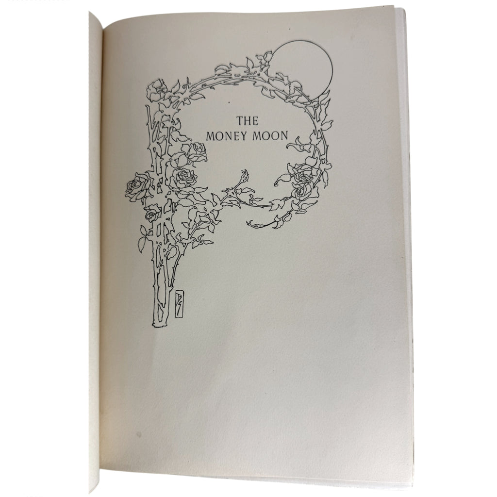 An open book showing a cream-colored page with a black line art illustration of a floral wreath enclosing a moon and the text 'THE MONEY MOON'.
