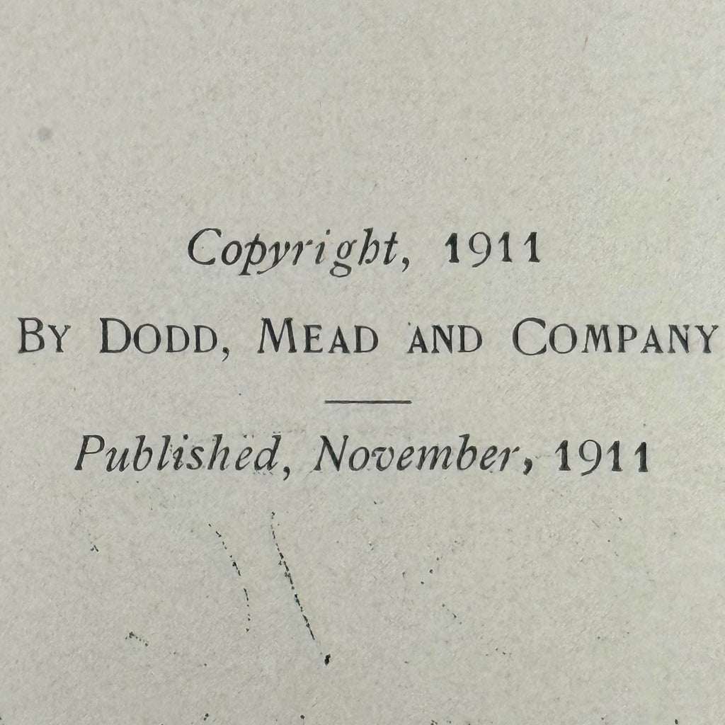 A close-up of a vintage book page with printed text reading 'Copyright, 1911 By Dodd, Mead and Company Published, November, 1911' on aged off-white paper.