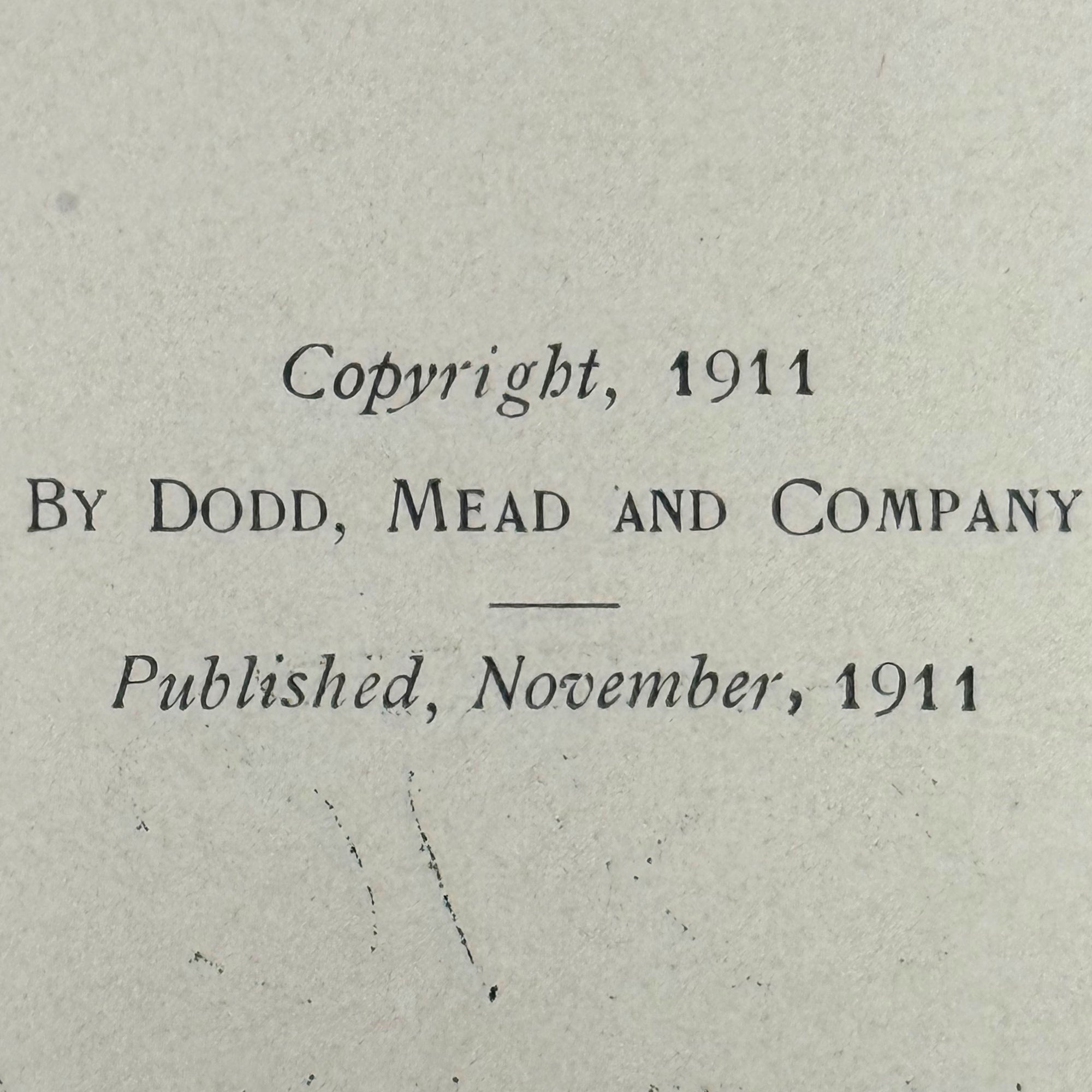 A close-up of a vintage book page with printed text reading 'Copyright, 1911 By Dodd, Mead and Company Published, November, 1911' on aged off-white paper.