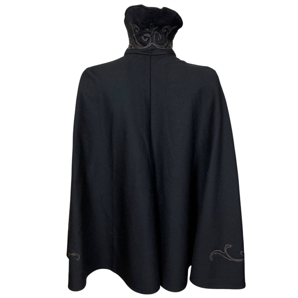 Full back view of late Victorian black wool cape showing flared silhouette and broad hemline