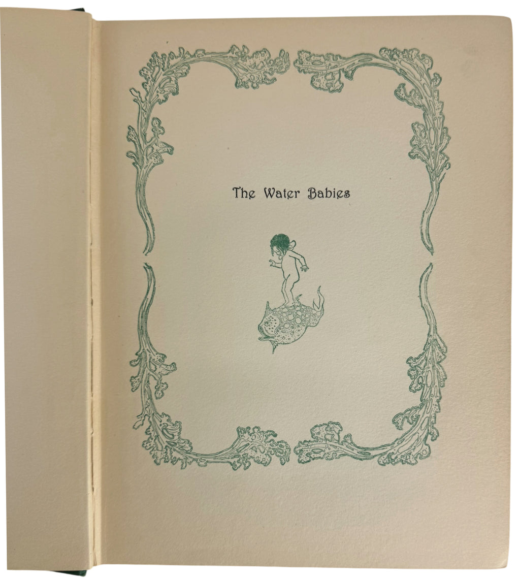 An open antique book showing a cream-colored page with a green decorative border and the title 'The Water Babies' centered above a small line drawing of a child with a fish tail.