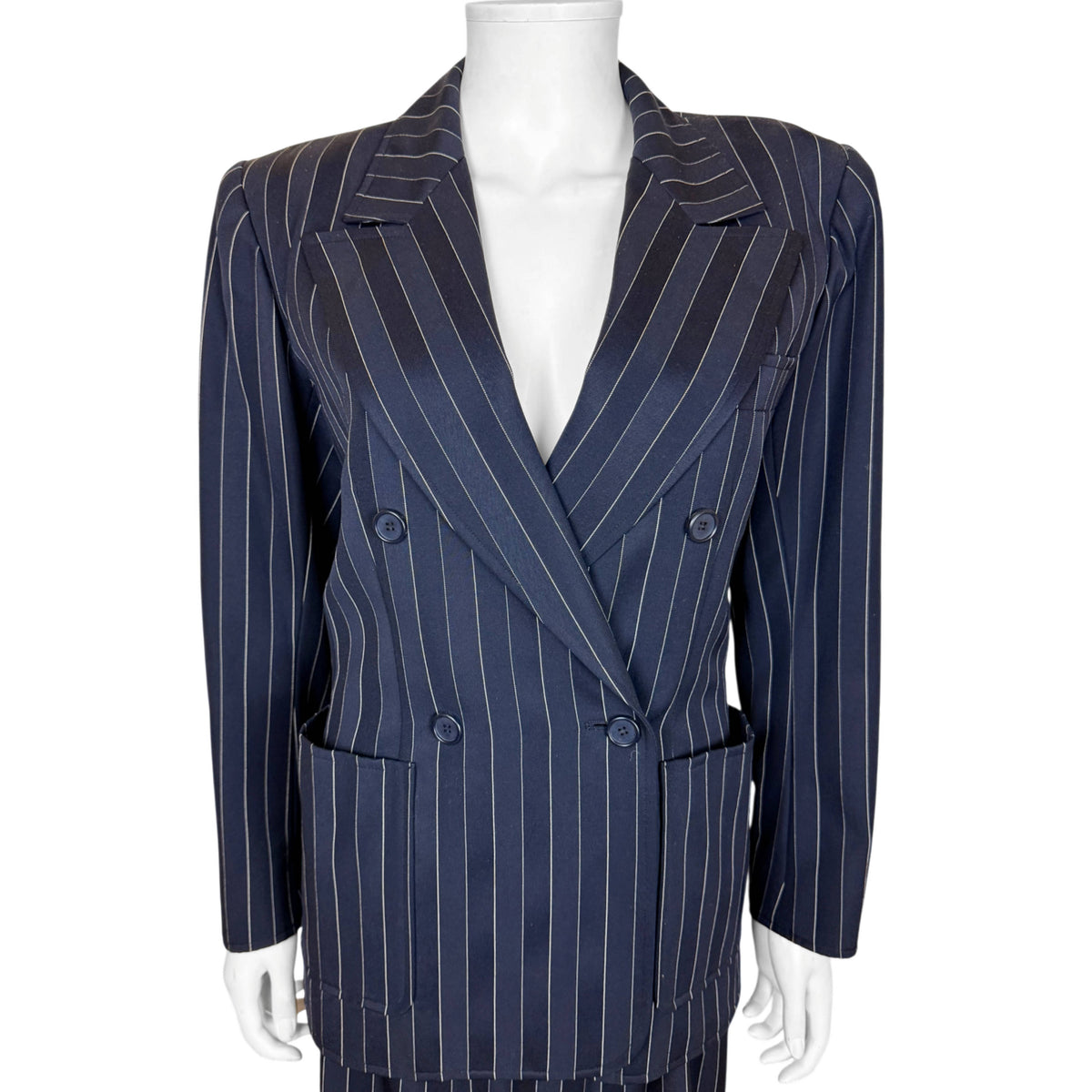 Close-up of Yves Saint Laurent double-breasted navy pinstripe jacket with peak lapels and patch pockets